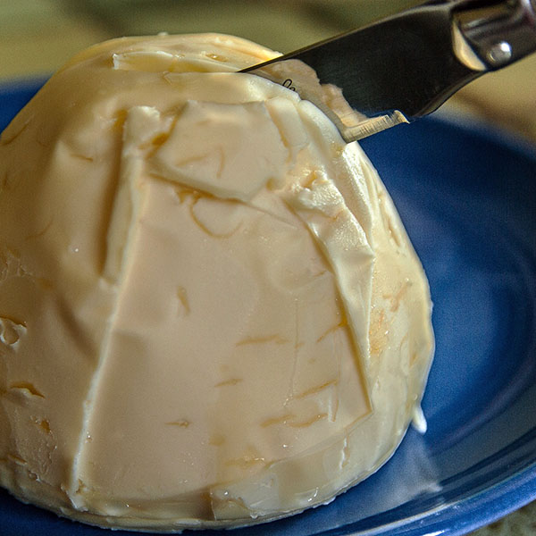 Large pat of butter with knife